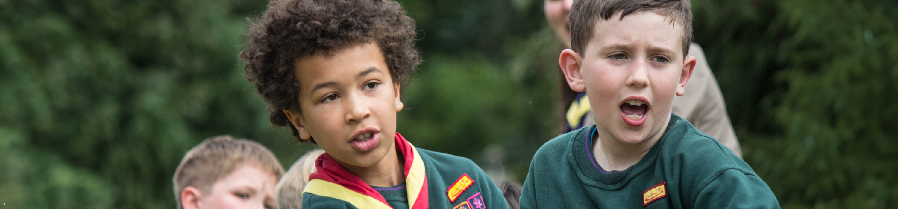 Children dressed in Cubs uniforms doing a tug of war